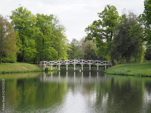 1.	Cobham, UK - April 2019 -  Reflection Of A Japanese Bridge In Water At Painshill Park A Landscape Garden In, Surrey, UK