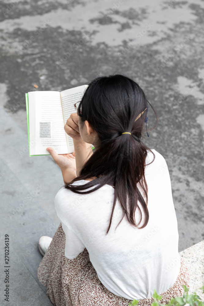 Girl reading a book in Vietnamese Language