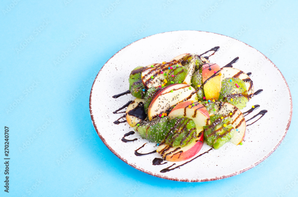 Tasty fruit salad on bright pastel background Tasty fruit salad on bright pastel background