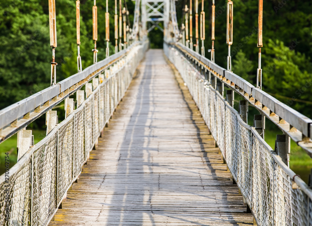 Obraz premium View of the pedestrian bridge through the Neman River in the city Mosty, Republic of Belarus