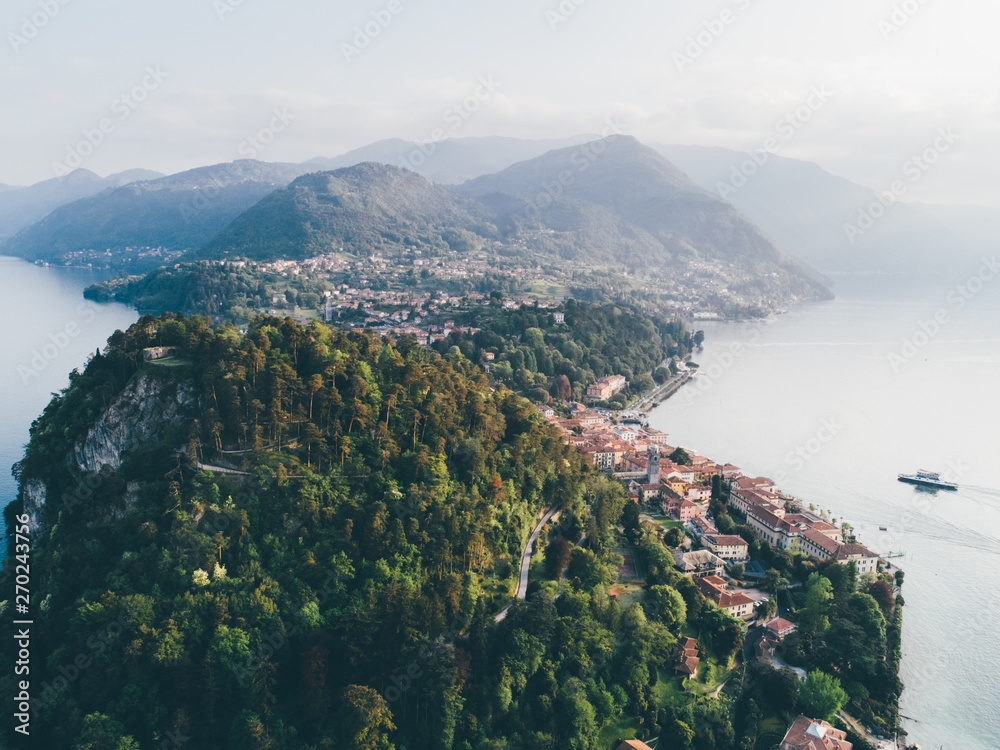 High top landscape of Bellagio city placed on cape with mountains and blue lake. Como, Italy.