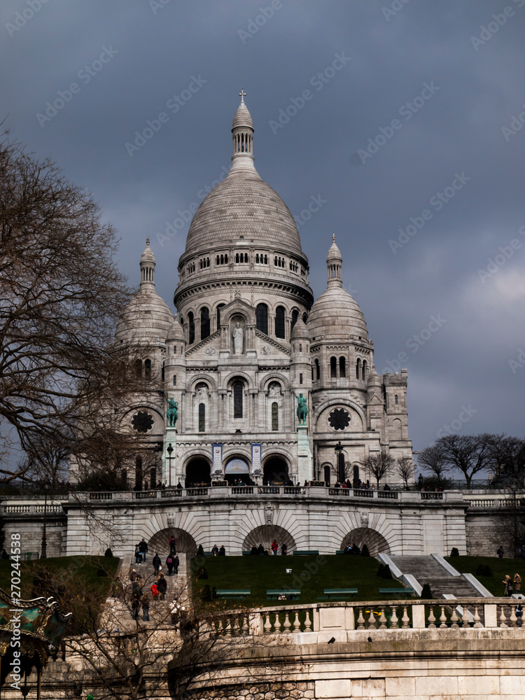 Paris, France, February 22, 2013: The Sacred Heart Basilica on the Montmartre hill in Paris in France Paris, France, February 22, 2013: The Sacred Heart Basilica on the Montmartre hill in Paris in France