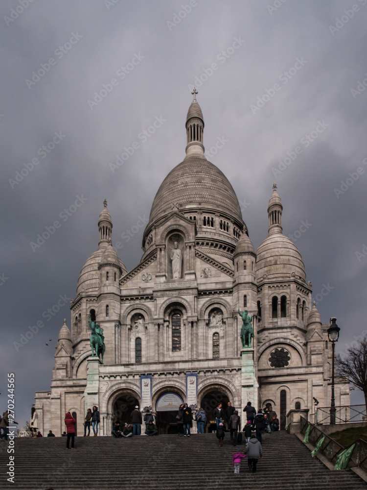 Paris, France, February 22, 2013: The Sacred Heart Basilica on the Montmartre hill in Paris in France