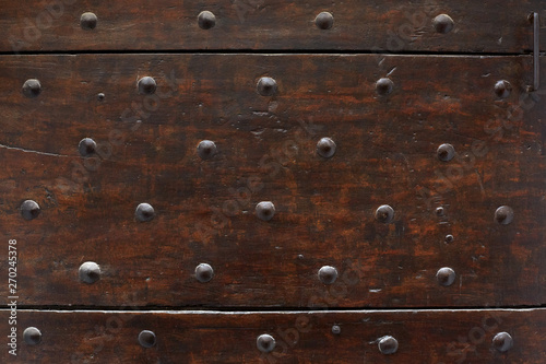 Old wooden door with nails texture background