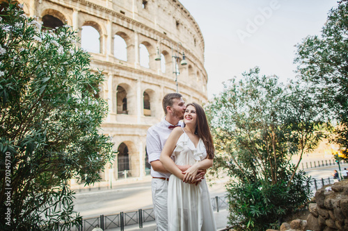 Photography young beautiful couple in white clothes stands against the background of the Col
