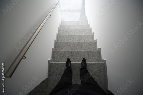 Man Standing in the Staircase with a Light.