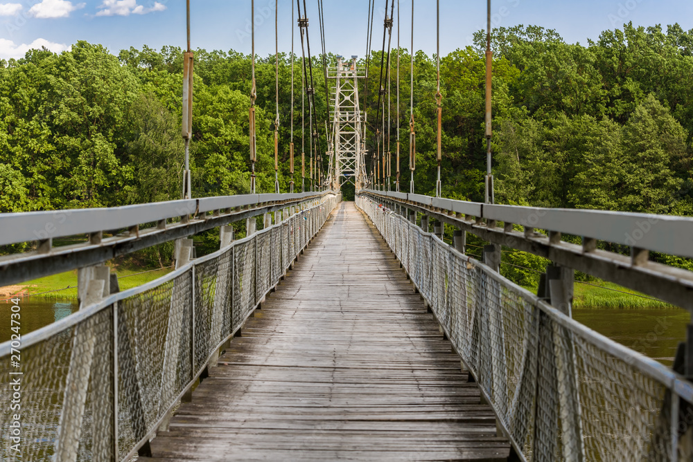 Obraz premium View of the pedestrian bridge through the Neman River in the city Mosty, Republic of Belarus