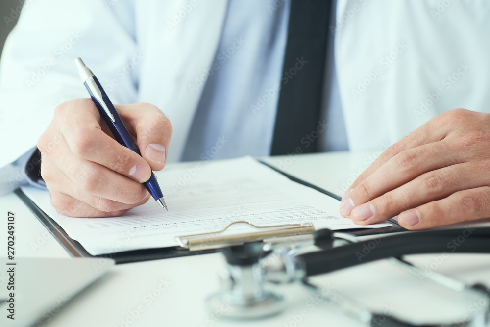 Mid section of male doctor writing write prescription to patient at worktable. Panacea and life save, prescribing treatment. Mid section of male doctor writing write prescription to patient at worktable. Panacea and life save, prescribing treatment.