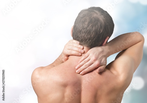 Strong man with neck pain  back view