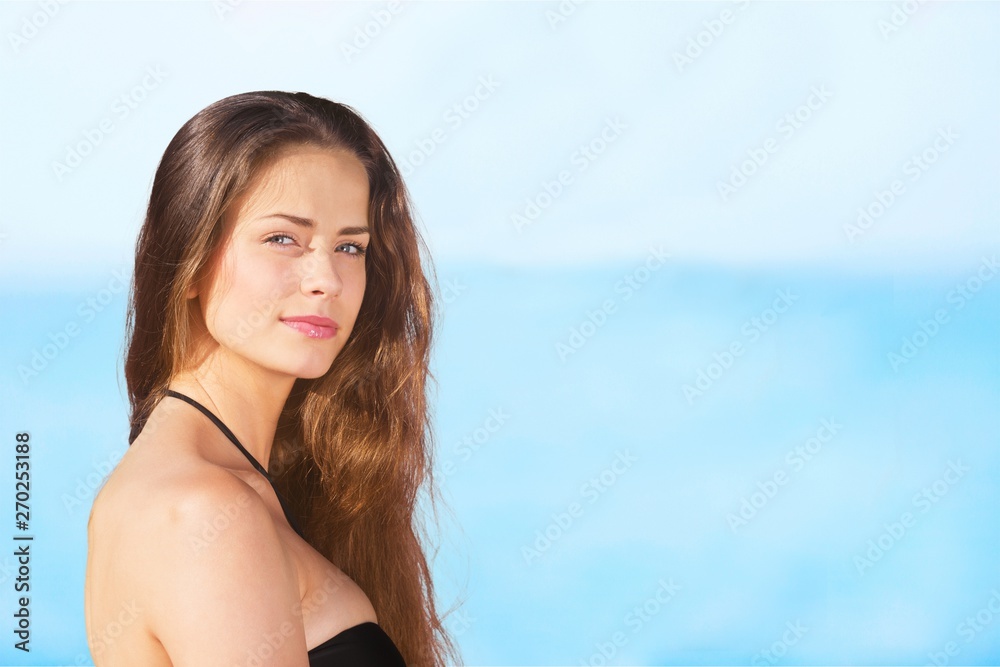 Outdoor summer portrait of pretty young smiling happy woman posing near the sea Outdoor summer portrait of pretty young smiling happy woman posing near the sea