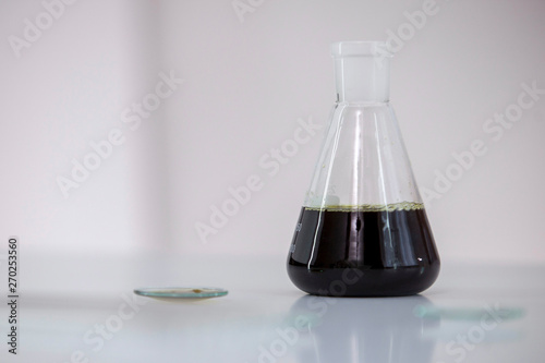 Scientist tearing the CBD oil with a precise dropper from a bowl into a tube