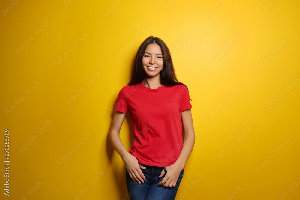 Attractive young woman posing on color background Attractive young woman posing on color background