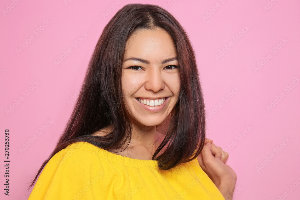 Attractive young woman posing on color background Attractive young woman posing on color background