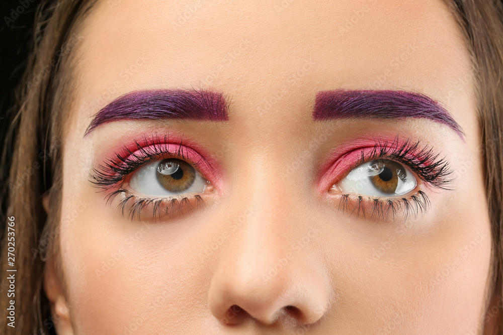 Young woman with dyed eyebrows and creative makeup, closeup