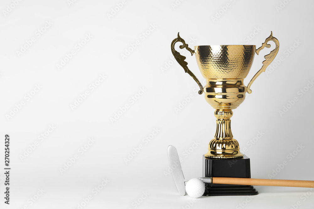 Golden trophy cup, golf club and ball on white background. Space for text Golden trophy cup, golf club and ball on white background. Space for text