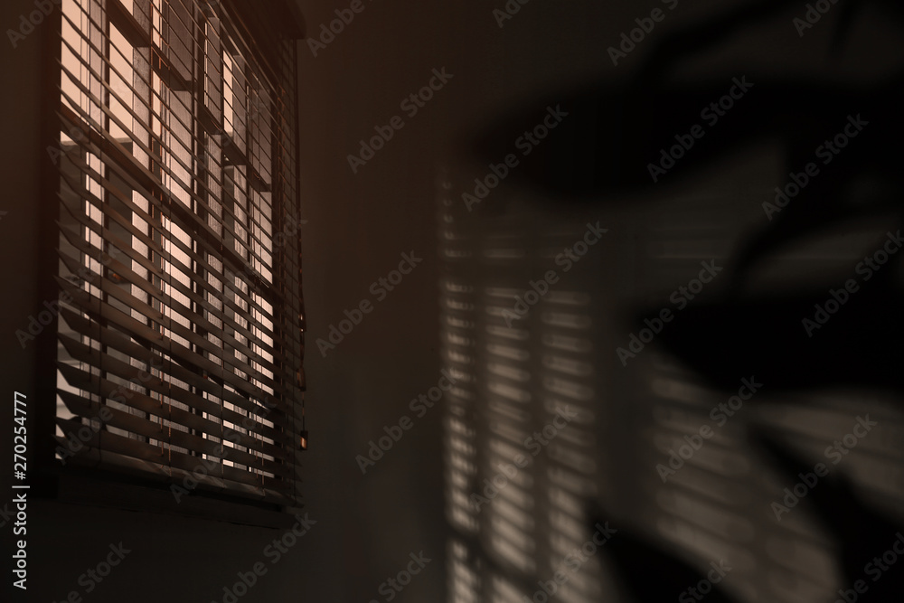 Window with horizontal blinds in room. Space for text Window with horizontal blinds in room. Space for text