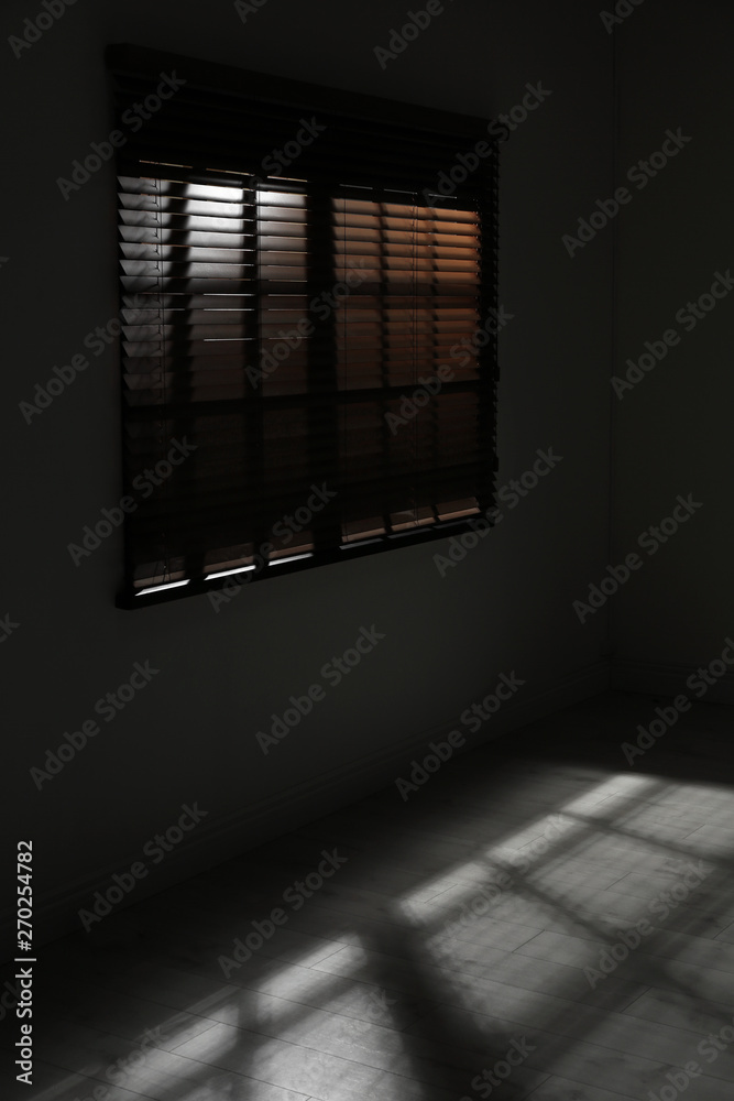 Window with horizontal blinds in dark room. Space for text Window with horizontal blinds in dark room. Space for text