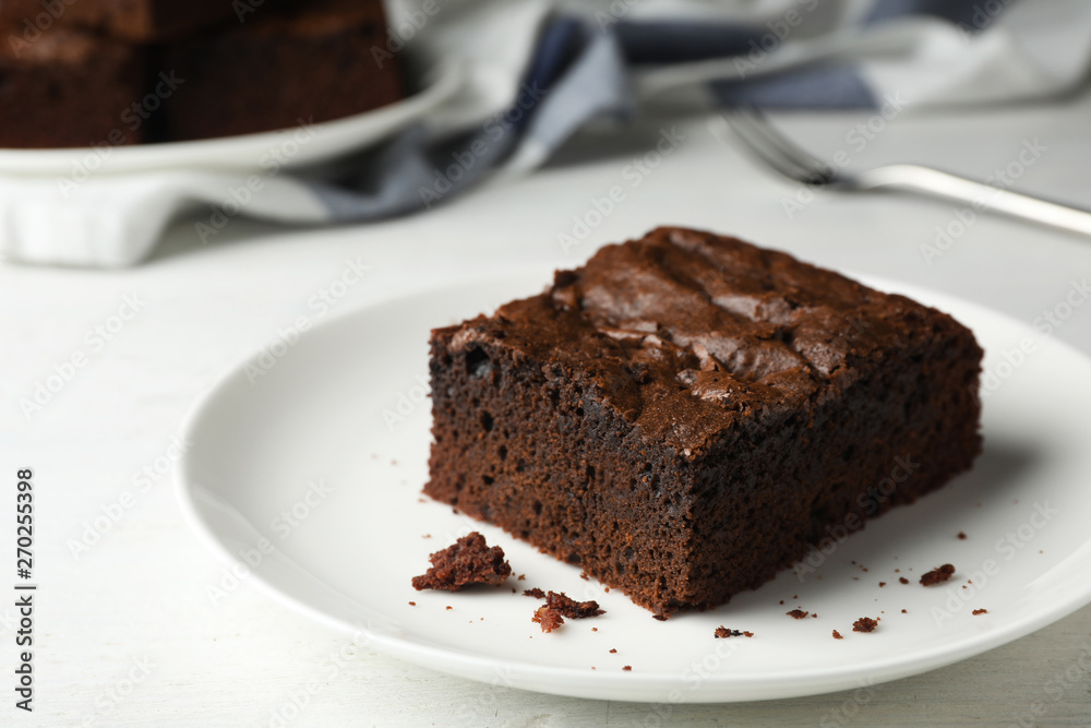 Plate with fresh brownie on white table, space for text. Delicious chocolate pie Plate with fresh brownie on white table, space for text. Delicious chocolate pie