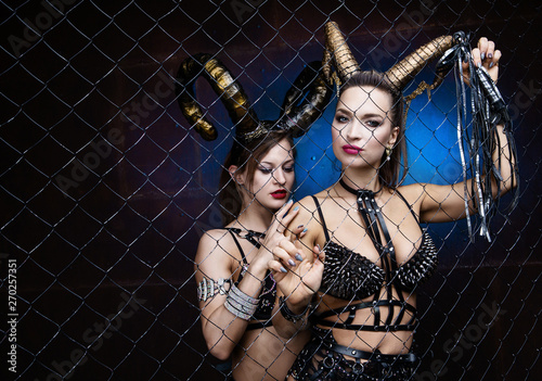 two beautiful dancers wearing leather and horns