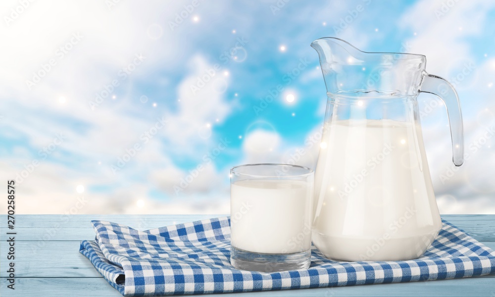Glass of milk and jar on background Glass of milk and jar on background