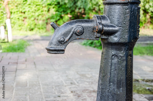 Water from the tap in the park.old style tap water sport in public park