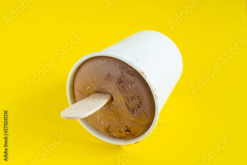 Paper cup with chocolate ice cream, just out of the freezer.