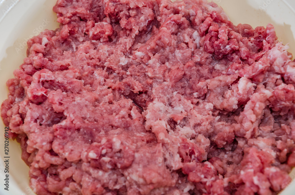minced meat in a large bowl close-up. View from above.