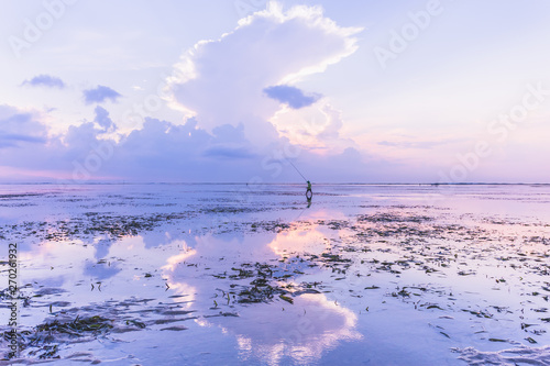 Reflection of fisherman in Bali at sunrise photo