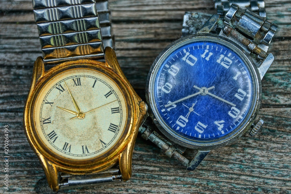 Fototapeta premium two yellow and blue old shabby watch with a metal strap 