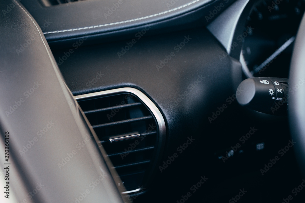 Car conditioner. The air flow inside the car. Detail interior. Air ducts, deflectors on the car panel