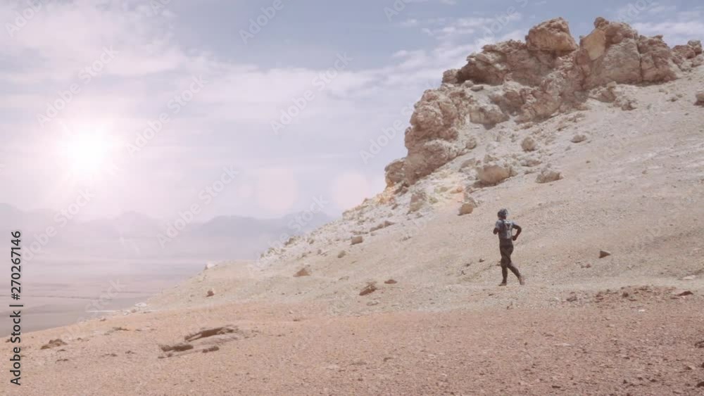 Man runs on the desert alone. Runner on cross-country road on the Atacama desert. Slow motion Man runs on the desert alone. Runner on cross-country road on the Atacama desert. Slow motion