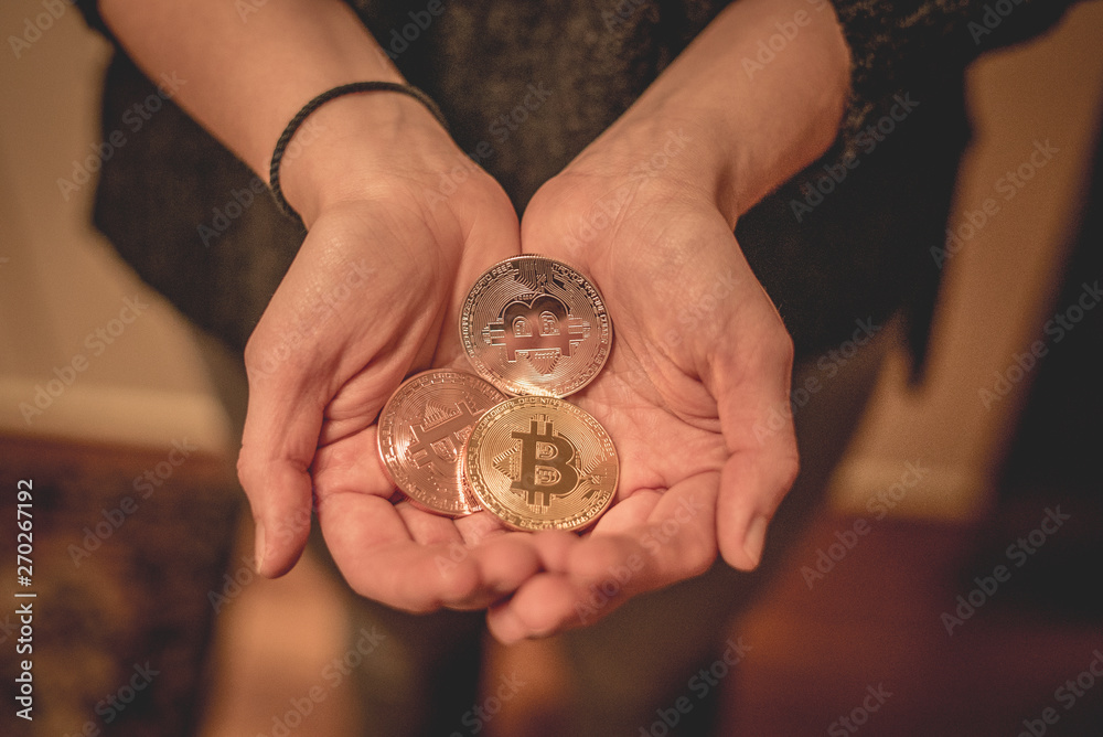 Cryptocurrency golden bitcoin coin. Man holding in hand symbol of crypto currency - electronic virtual money for web banking and international network payment, selective focus, toned Cryptocurrency golden bitcoin coin. Man holding in hand symbol of crypto currency - electronic virtual money for web banking and international network payment, selective focus, toned