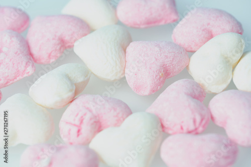 background color picture with heart-shaped pink and white hard candies