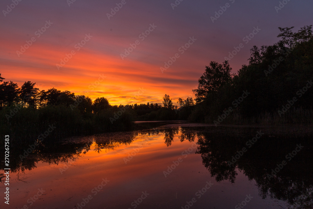 Obraz premium Sunset in the national park near Waterschei in Genk, Belgium with amazing colors in the sky. The park is a former mining area with amazing views