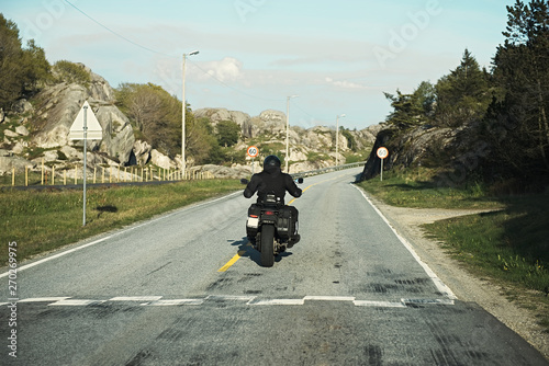 back view of two motorcyclists on mountain road