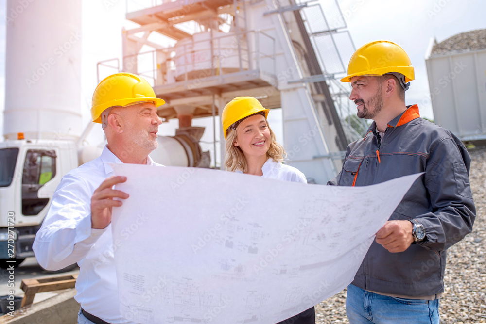 Group of engineers on site, visiting ready mix concrete plant and discussing construction plan Group of engineers on site, visiting ready mix concrete plant and discussing construction plan