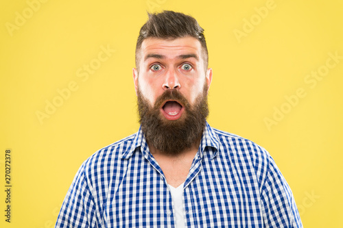Wondering every time. Man bearded hipster wondering face yellow background close up. Guy surprised face expression. Hipster emotional surprised expression. Rustic surprised macho. Surprising news