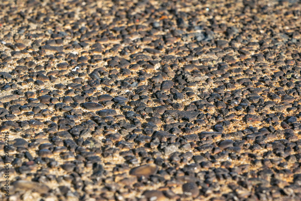 A rough wall texture of small burnt pebbles A rough wall texture of small burnt pebbles