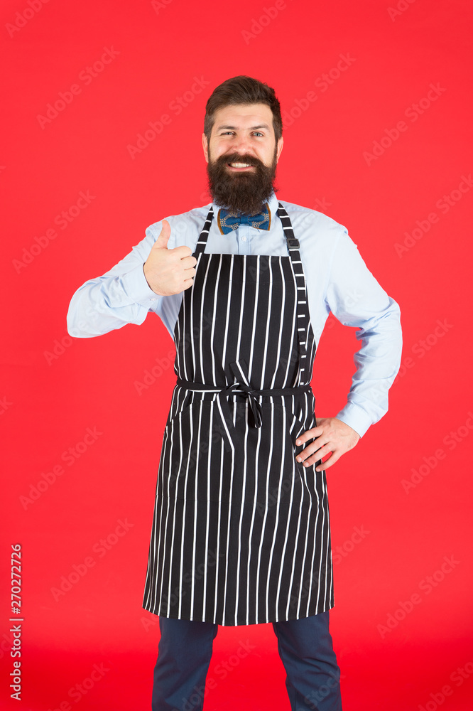 Giving his approval. Bearded man giving thumbs up approval hand gesture. Hipster gesturing approval sign. Cheerful cook or barista expressing his approval to meal or cocktail