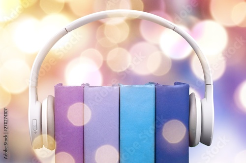 Audio book concept,books and headphones on background photo