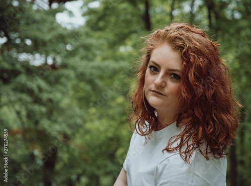 Attractive young woman with curly coppery hair