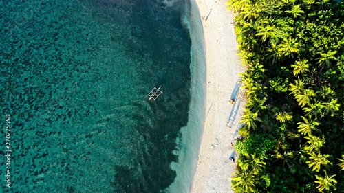 Top down view of tropical beach with turquoise water and white sand