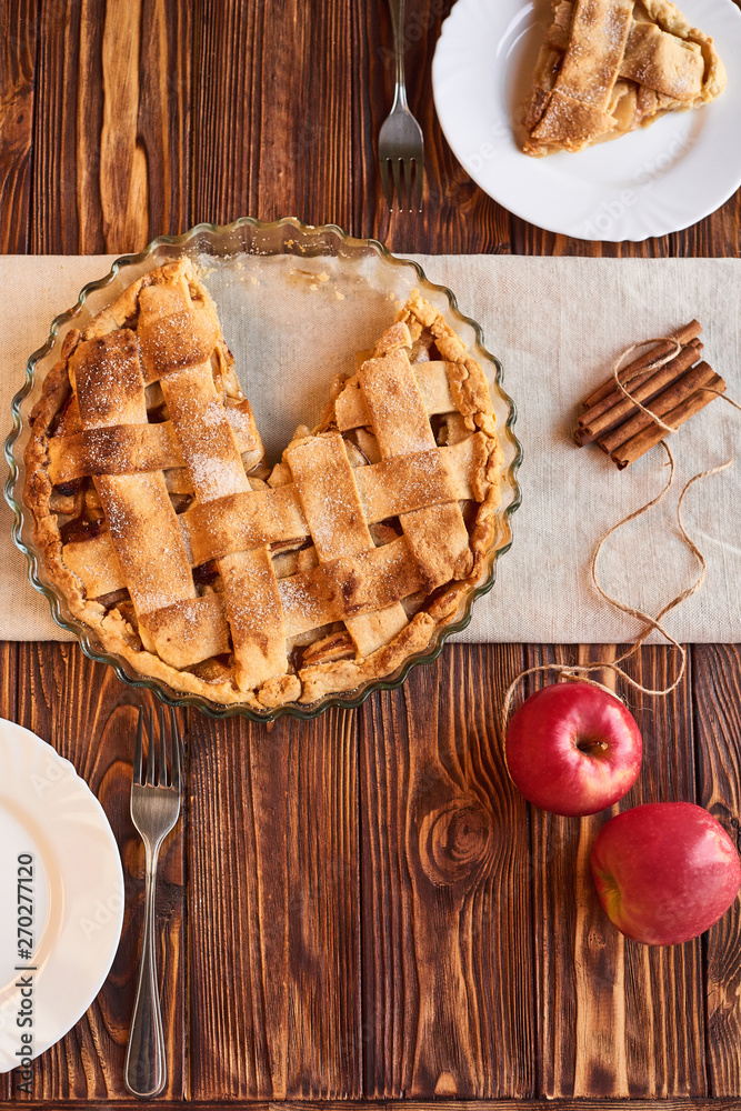 Tasty homemade apple pie. American pie. Apples. Cinnamon. Plate. Linen towel. Wooden background. Top view