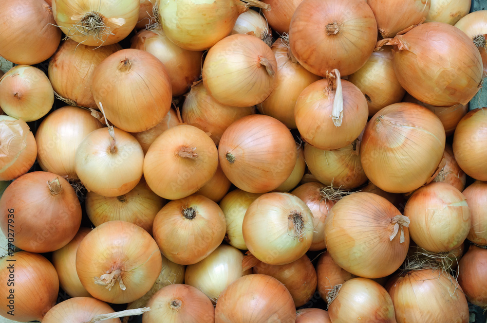 Fresh straw yellow onions on the market. Fresh straw yellow onions on the market.