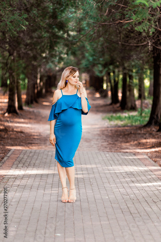 pregnant beautiful woman walking in the park