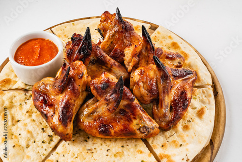 tasty grilled chicken wings with sauce
