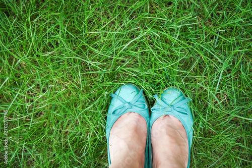 beautiful legs on the grass in the summer park