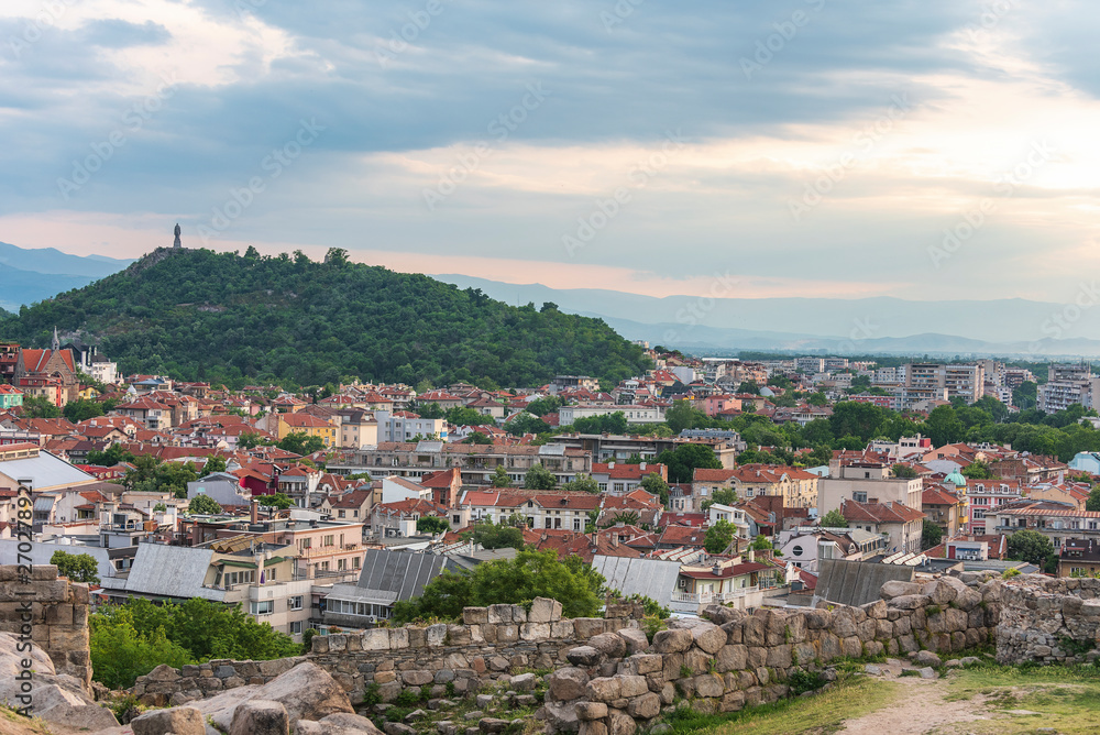 Part of ancient fortress wall on top of the Nebet tepe Hill in Plovdiv city, Bulgaria. Panoramic view with warm sunset.