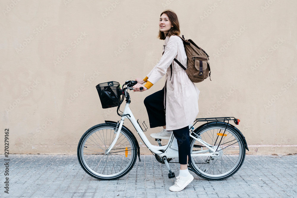 Woman with e-bike at a wall Woman with e-bike at a wall