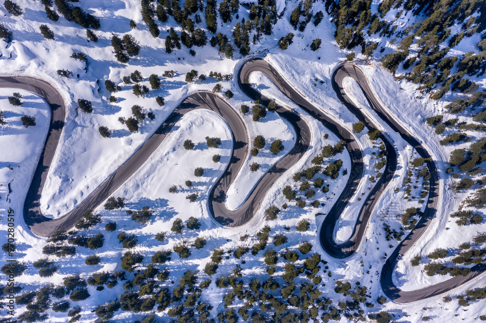 Aerial view of road passing through snowy landscape during winter Aerial view of road passing through snowy landscape during winter